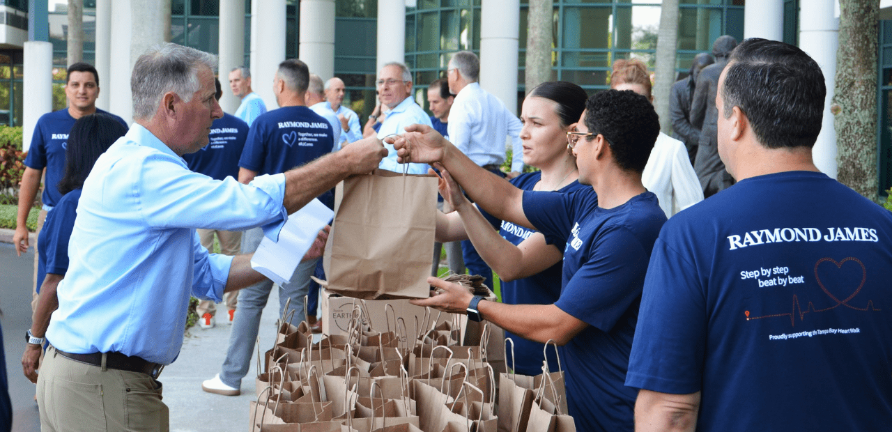 Paul Shoukry providing a hot meal kit at Raymond James event